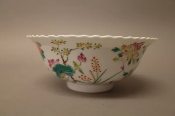 A Chinese famille-rose bowl, 19th/20th century, painted in the centre with a bat and two peaches, the exterior painted with flowering peony, prunus, c