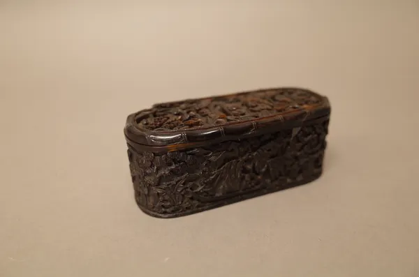 A Canton tortoiseshell oblong snuff box and hinged cover, 19th century, the cover, sides and base carved with figures, pavilions and trees, the unders