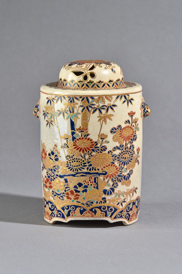 A Japanese Satsuma koro, 19th century, of cylindrical form, enamelled with flowers and bamboo, set with shishi mask handles, pierced domed cover, blac