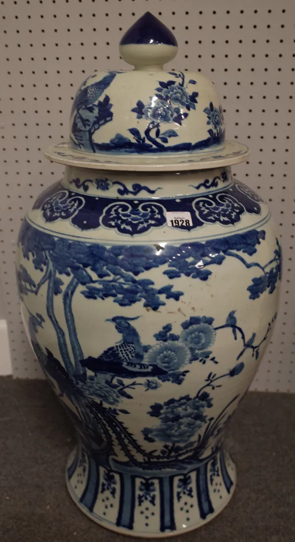 A very large Chinese blue and white baluster vase and cover, late 19th/early 20th century, painted with phoenix amongst flowering plants, 81cm. high,