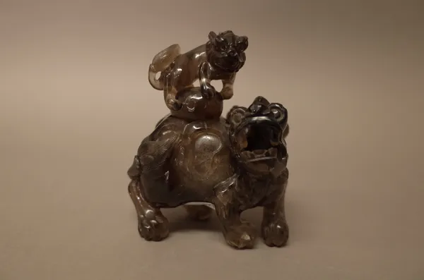 A Chinese smoky quartz censer and cover, late 19th/20th century, carved as a lion and two cubs, 13cm. high, (2).