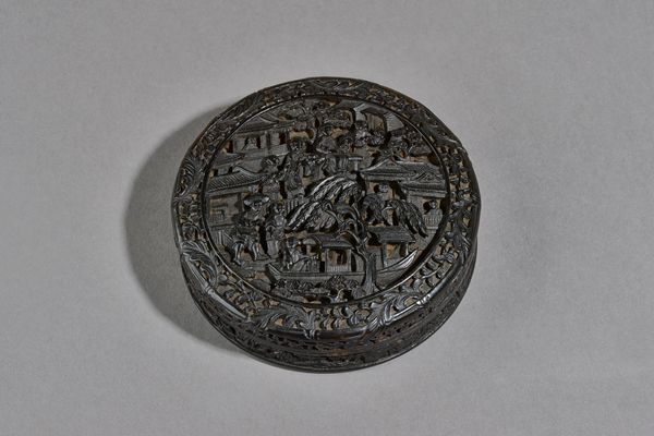 A Chinese export tortoiseshell circular snuff box and cover, 19th century,  the cover and underside of base finely carved with figures, a boat, trees