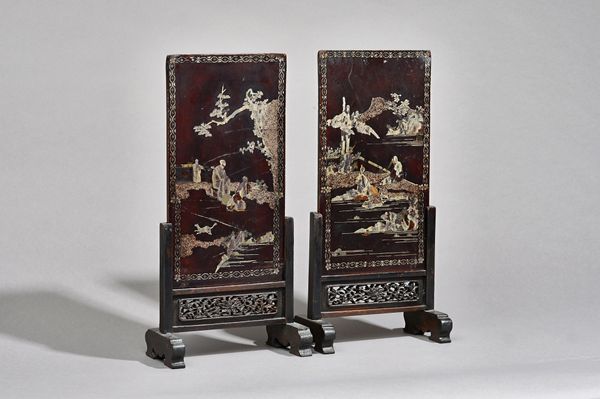 A pair of Chinese mother-of -pearl inlaid table screens, 18th/19th century, of rectangular form on pierced wood stands, each inlaid with figures in la