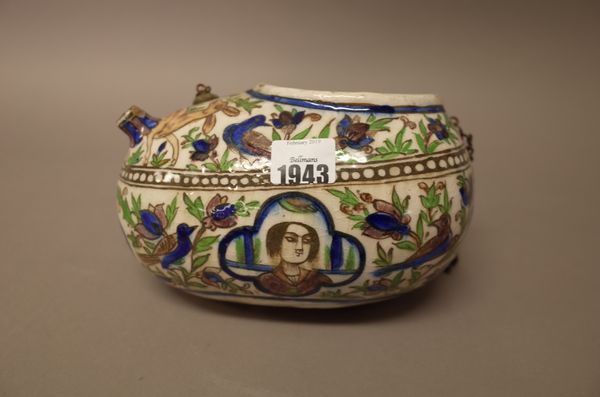 A Qajar pottery begging bowl (kashkul), late 19th century, painted with four head and shoulder portrait panels against a ground filled with birds, a d