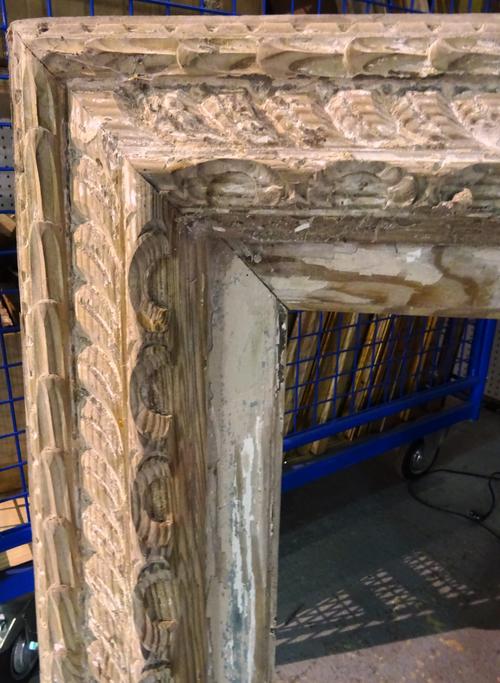 A group of three late 19th/ early 20th century distressed carved wooden picture frames, the largest 81cm x 98cm, (3).