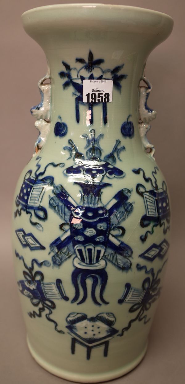 A Chinese blue and white celadon-ground two-handled baluster vase, late 19th century, painted with Buddhist emblems, set with lion and cub handles, 42