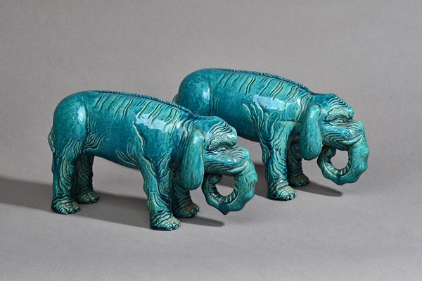 A pair of Chinese turquoise glazed figures of elephants, 19th century, each standing four-square, the bodies incised to simulate the skin folds, 25.5c