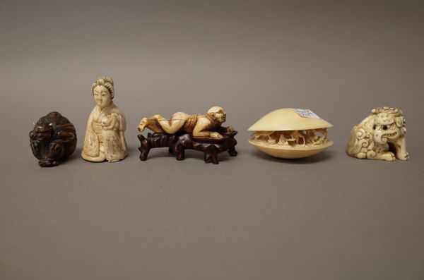 A group of Japanese carvings, late 19th/early 20th century,  comprising; an ivory  netsuke of a seated  baku, 4.25cm. high; an ivory `clam's dream',