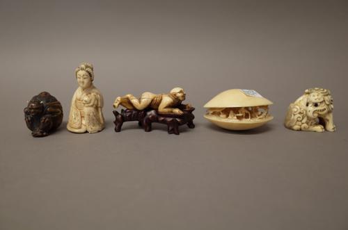 A group of Japanese carvings, late 19th/early 20th century,  comprising; an ivory  netsuke of a seated  baku, 4.25cm. high; an ivory `clam's dream',