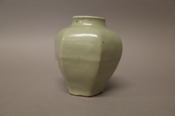 A Chinese porcelain jarlet, of hexagonal form, covered in a celadon glaze, blue painted four character Xuande mark, 10cm. high.