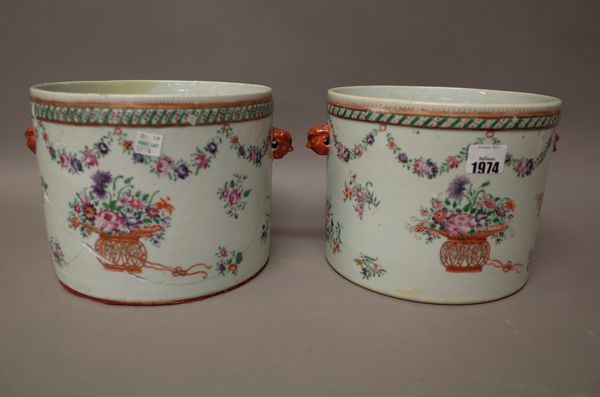 A pair of Chinese export famille-rose cylindrical jardinieres, Qianlong, late 18th century, each set with iron-red lion mask handles, enamelled with b