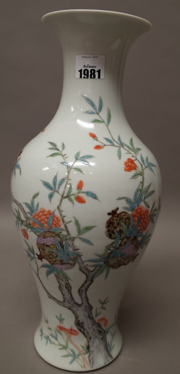 A Chinese famille-rose vase, Republic period, 20th century, of slender baluster form, finely enamelled with branches of flowers and pomegranates, iron