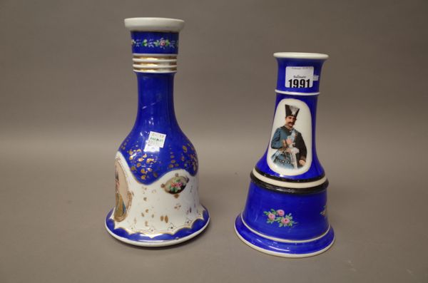 Two porcelain huqqa bases, 20th century, each printed with portraits of Shahs of Iran against a blue ground, 22cm. and 25.5cm. high, (2).