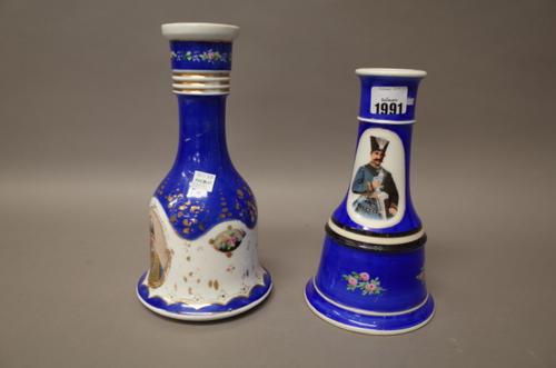 Two porcelain huqqa bases, 20th century, each printed with portraits of Shahs of Iran against a blue ground, 22cm. and 25.5cm. high, (2).