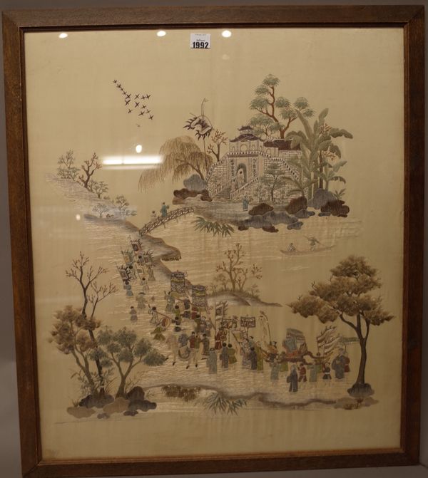 A Chinese embroidered silk panel, late 19th/20th century, worked with a procession of figures making their way to a temple on an island, 69cm. by 59cm