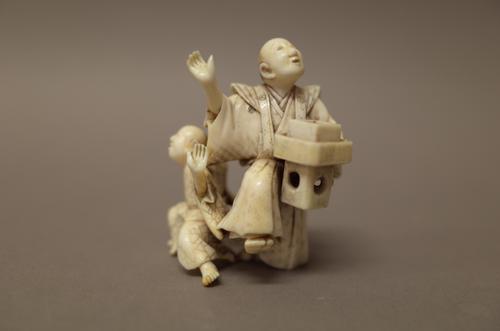 A small Japanese ivory okimono of two dancers, Meiji period, one standing with right arm and right leg raised, the other, a child, standing with both
