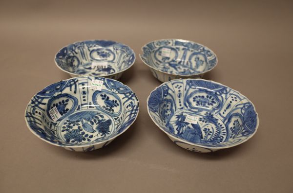 Four Chinese small blue and white kraak porcelain bowls, 17th century, each painted to the interior with a bird on a rock amongst flowers beneath a pa