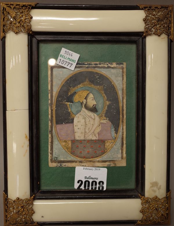 A head and shoulders portrait of a Maharajah, India, probably 17th century, opaque pigments on paper, 9cm. by 7cm., mounted, framed and glazed.