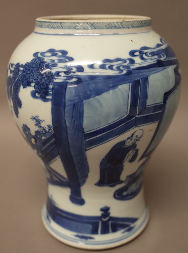 A Chinese blue and white baluster vase, Kangxi, painted with a kneeling figure and three attendants around a stand on which sits Budai, the reverse wi