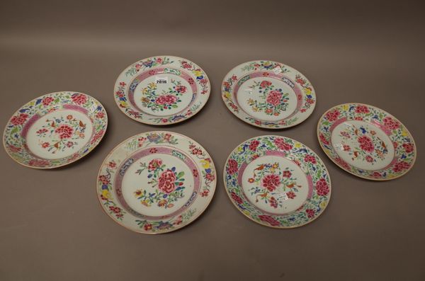 Three Chinese famille-rose plates, Qianlong, each painted in the centre with flowering peony and other flowers, the border scattered with branches of