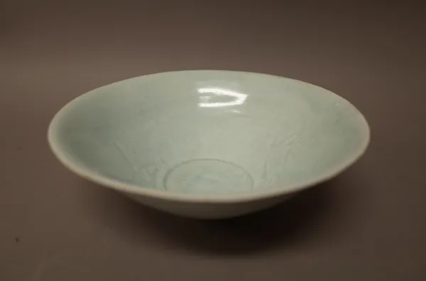 A Chinese qingbai glazed bowl, Song dynasty, the interior with two fish beneath a bluish transparent glaze, 18cm. diameter.