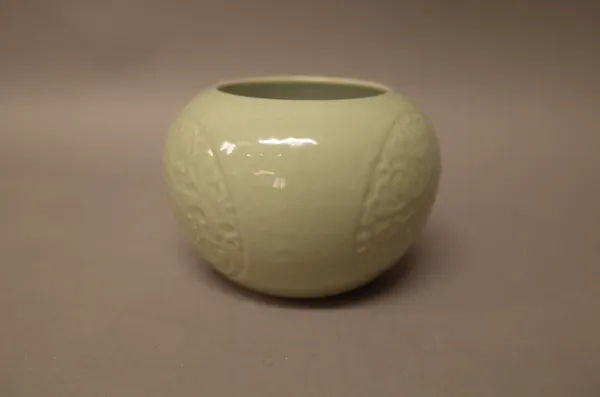A Chinese celadon glazed porcelain vase, blue Qianlong seal mark but later, of compressed globular form, moulded with three dragon roundels, 8.5cm. hi