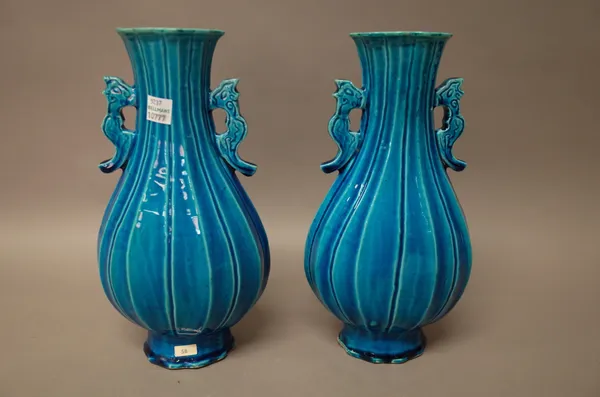 A pair of Chinese turquoise glazed two-handled vases, 19th century, of fluted pear form, 25cm. high, (2).