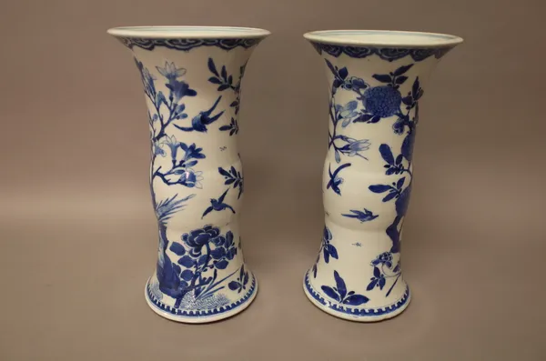 A pair of Chinese blue and white beaker vases, 19th century, each painted with two pheasants amongst rocks and flowering branches, 30.5cm. high, (2).