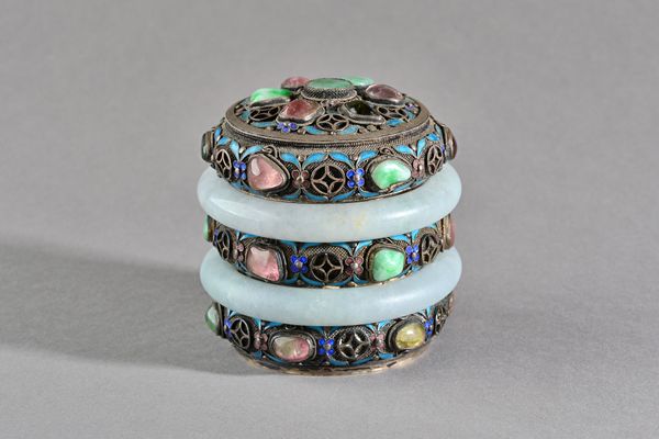 A Chinese silver and enamelled cylindrical box and cover, 20th century, encircled with two jade rings and inset with a variety of gems including tourm