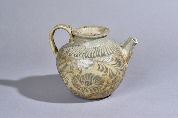 A Korean iron-decorated celadon stoneware ewer and a cover, probably Goryeo dynasty, 12th century, the bulbous body painted in underglaze iron with fl