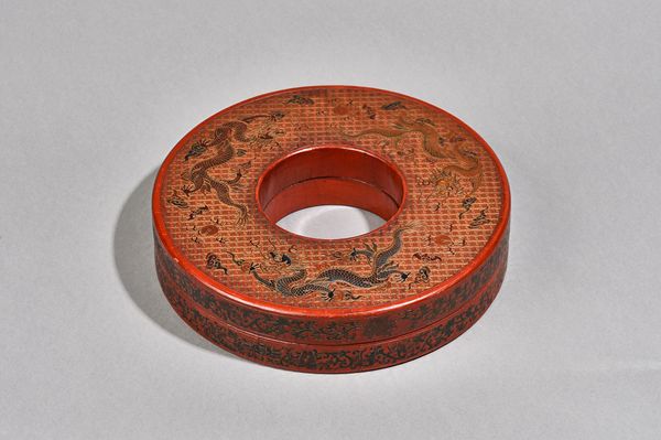 A Chinese red lacquer circular necklace box and cover, six character Qianlong mark but later, decorated with three dragons chasing flaming pearls amon