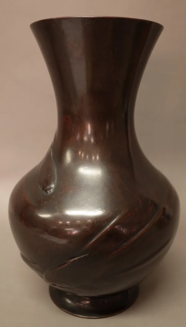 A Japanese bronze vase, 20th century, of baluster form, decorated in low relief with three fish swimming, signed, 33cm. high.