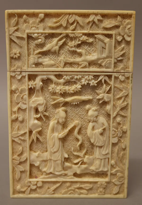A Canton ivory rectangular card case, late 19th century, each side carved with a panel of figures in a landscape, the cover with buildings and a bird,