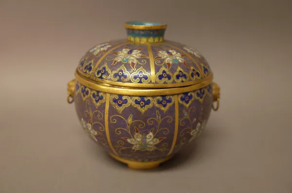 A Chinese cloisonné two-handled bowl and cover, late Qing dynasty, worked with panels of lotus flowers against a lilac ground between lappet and ruyi