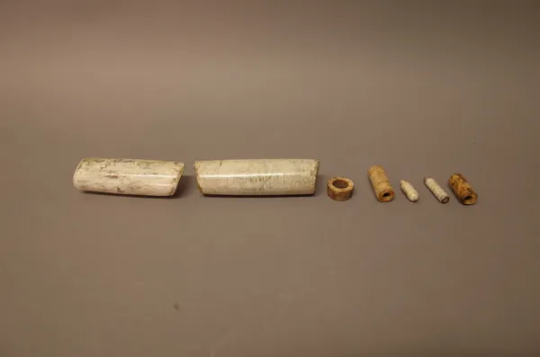 A group of five Chinese archaic jade beads, probably circa 2000 BC, the larger two calcified, the three smaller beads of cream and brown tone, 0.5cm.