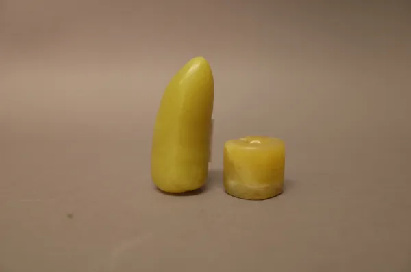 Two Chinese yellow jade beads, possibly Shang dynasty, one of split oval section, the other of bean form with ribbing to one side, 2cm. and 5cm. lengt