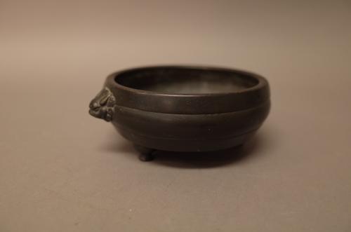 A Chinese bronze tripod censer, six-character Xuande mark around rim but probably 18th/19th century, cast with animal mask handles, engraved hare to b