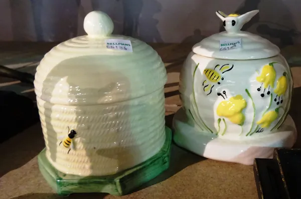Two 20th century ceramic honey pots and a similar butter dish, each decorated with bees, (3).