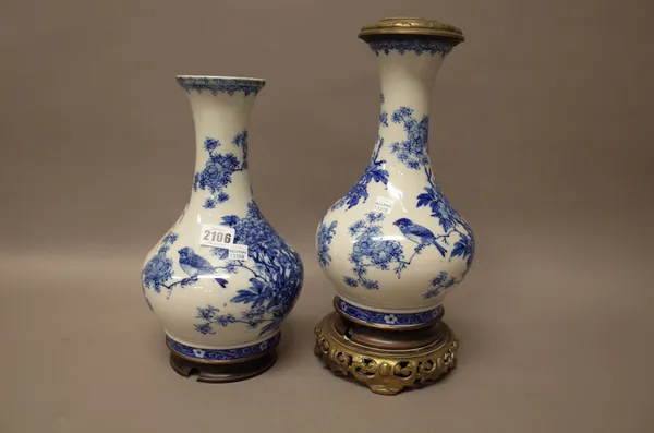 A pair of  blue and white porcelain vases mounted as lamps, probably Seto, late 19th/early 20th  century, of bottle form, each painted with a bird per