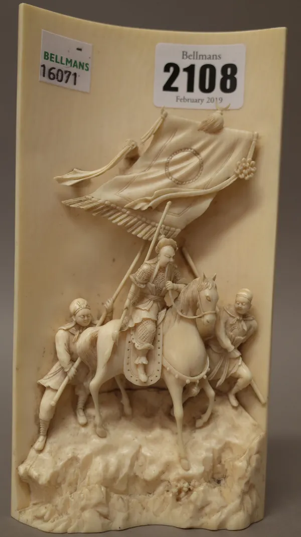 A Chinese carved ivory panel, late 19th/early 20th century, carved in high relief with a figure on horseback flanked by two standing attendants, one h