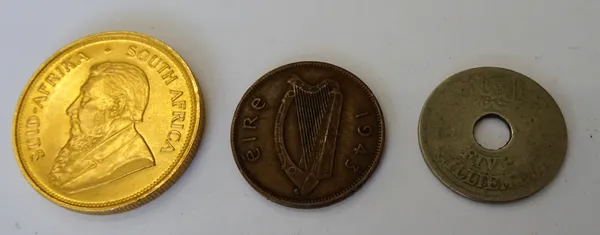 A Krugerrand 1974, an Irish halfpenny 1943 and another coin, (3).