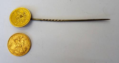 A George V half sovereign 1911 and a U.S.A two and a half dollars (the date obscured) mounted as a stick pin.