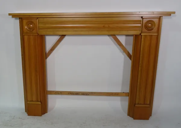 A 20th century beech fire surround with fluted decoration, 158cm wide x 115cm high, aperture 94cm wide x 93cm high.