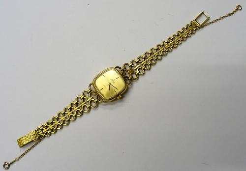 An Omega Automatic De Ville 18ct gold lady's bracelet wristwatch, the curved square gilt dial with black hands, the two row graduated circular and bar