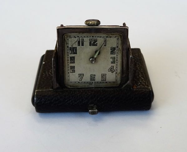 A silver and leather rectangular cased travelling watch, the square silvered dial with Arabic numerals, the case detailed 0,925.