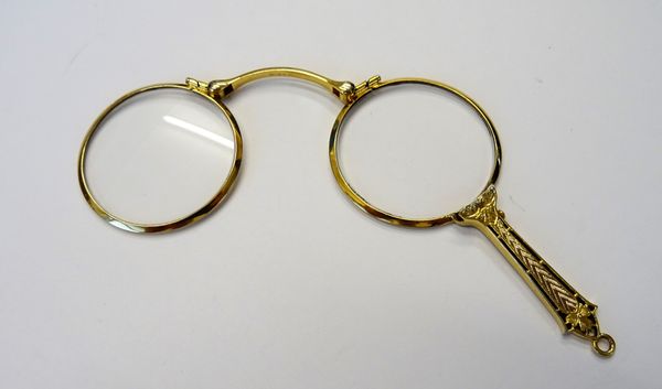 A pair of gold mounted folding sprung lorgnettes, fitted with circular lenses, the handle with engine turned and pierced decoration, probably American