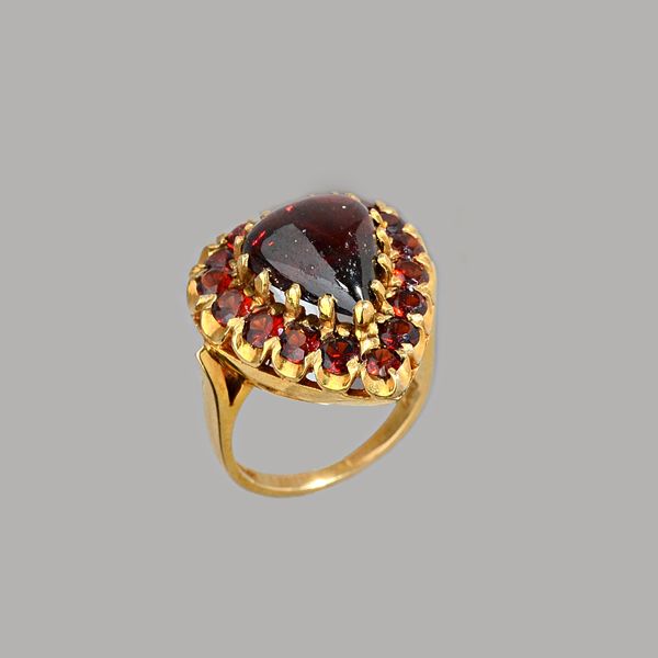 A 9ct gold and garnet cluster ring, claw set with the carbuncle garnet to the centre, in a surround of circular cut garnets, London 1976, ring size M,