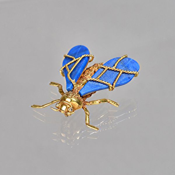 A Chaumet 18ct gold, lapis lazuli and diamond brooch, designed as a winged insect, having lapis lazuli wings and circular cut diamond set eyes, gross