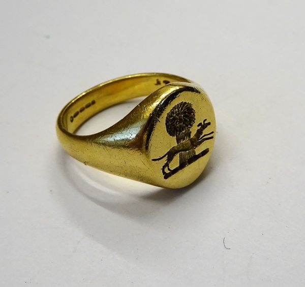 An 18ct gold oval signet ring, crest seal engraved, ring size L, weight 9.5 gms, with a box.