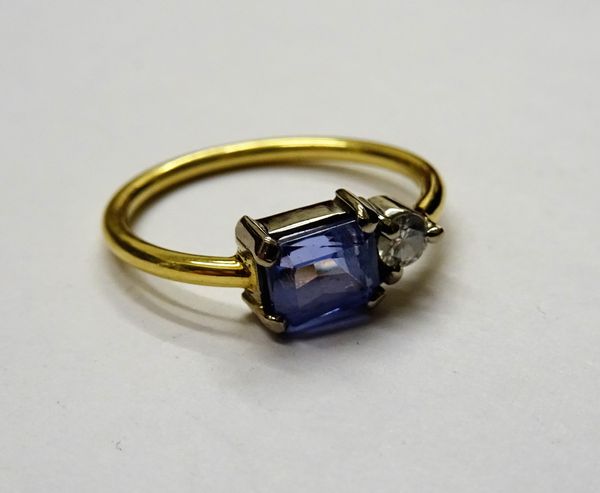 A diamond and tanzanite two stone ring, claw set with a circular cut diamond and with a rectangular cut tanzanite, ring size M.